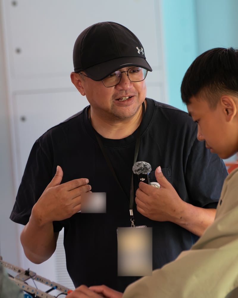 A conversation beside a robotics activity.