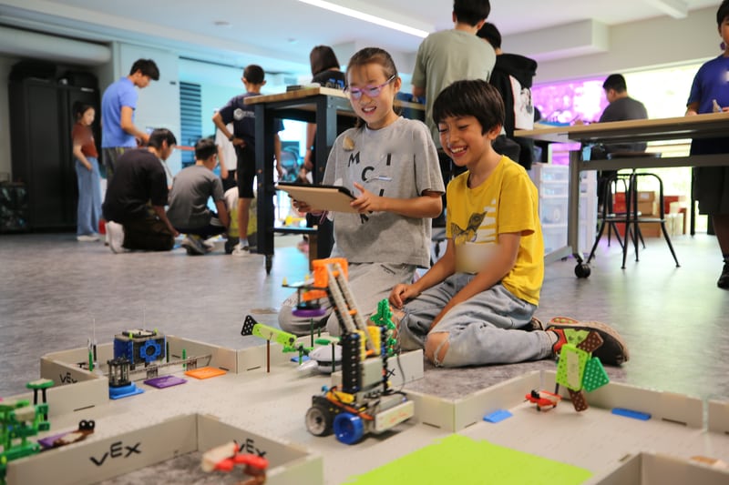 Two participants exploring robots on an activity field.